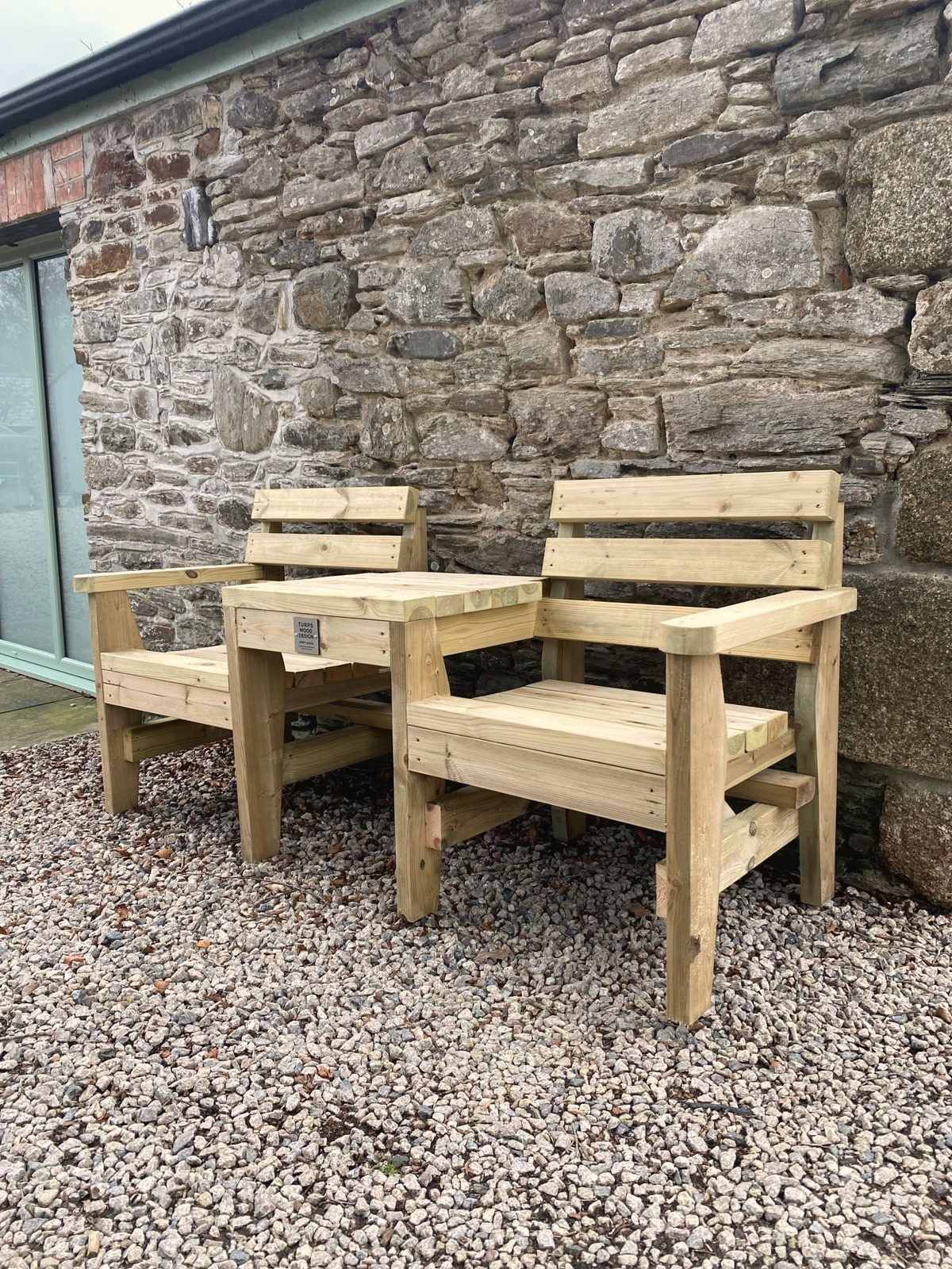 A companion chair, two timber seats joined by a side table